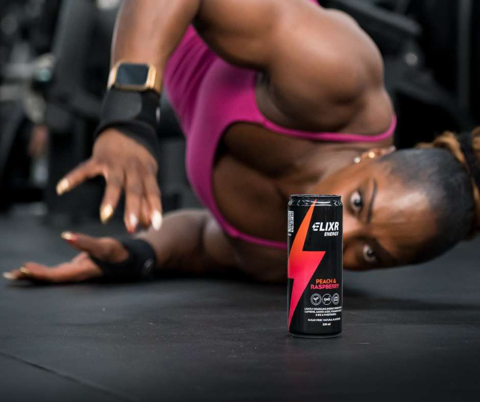 Ms Olympia with can of Elixr energy drink