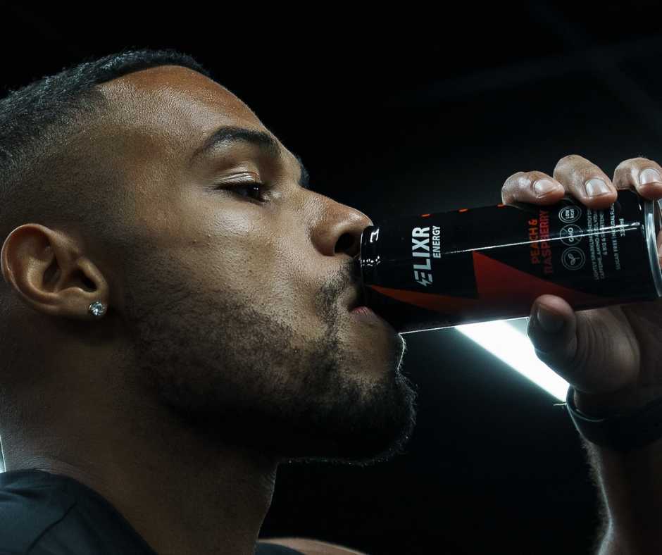 Man drinking a can of Elixr Peach and Raspberry